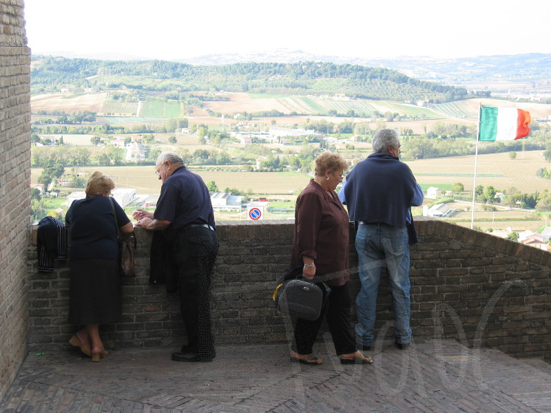 people looking at a flag and the hills